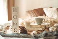 Still life details in home interior of living room and the inscription HOME. Books and cup of tea with cone and cotton. Read. Rest Royalty Free Stock Photo