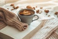 Still life in home interior of living room. Sweaters and cup of tea with a cone on the books. Read. Cozy autumn winter concept Royalty Free Stock Photo