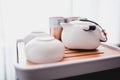 Still life details in home interior of living room. Sweaters and cup of tea with steam on a serving tray on a coffee table. Royalty Free Stock Photo