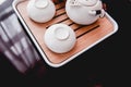 Still life details in home interior of living room. Sweaters and cup of tea with steam on a serving tray on a coffee table. Royalty Free Stock Photo