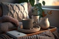 Still life details in home interior of living room Sweaters and cup of tea with steam on a serving tray on a coffee table Royalty Free Stock Photo