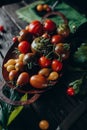 Still life, different varieties of tomato scattered on a wooden table, soft morning light, top view Royalty Free Stock Photo