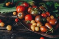 Still life, different varieties of tomato scattered on a wooden table, soft morning light, top view Royalty Free Stock Photo