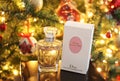 Still life of Dior perfume in front of the Christmas tree Royalty Free Stock Photo