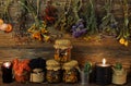 Still life with dry flowers and herbs, witch bottles, black candle and moss in jar