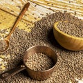 still life with dry lentils in bulk poured on a table and copper june meter with a bamboo wooden bowl