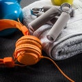 Still-life of earphones, hand grip, towel and kettle bell Royalty Free Stock Photo