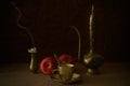 Still life - an empty cup, an oriental teapot, two apples and an extinguished candle.