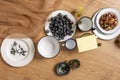 Still life with enameled and fine porcelain plates with blueberries, plants,