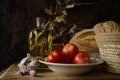 Still life with extra virgin olive oil, tomatoes, garlic and bread Royalty Free Stock Photo