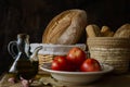 Still life with extra virgin olive oil, tomatoes, garlic and bread Royalty Free Stock Photo