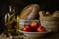 Still life with extra virgin olive oil, tomatoes, garlic and bread Royalty Free Stock Photo