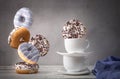 Still life with falling donuts and white cups Royalty Free Stock Photo