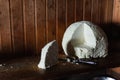 Still life with farmer cheese and a knife on rustic wooden background