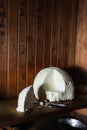 Still life with farmer cheese and a knife on rustic wooden background