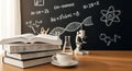 Science Desk Setup with Books and Blackboard Royalty Free Stock Photo