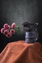 Still life with a flower branch and an old blowtorch Royalty Free Stock Photo