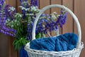 Still life with flowers and knitting in the basket Royalty Free Stock Photo