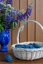 Still life with flowers and knitting in the basket Royalty Free Stock Photo