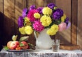 Still life with flowers in rustic style. pitcher of asters Royalty Free Stock Photo