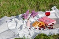 Still life and food photo. Cherry and waffle berries lie on a wicker round napkin and crumpled fabric