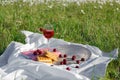 Still life and food photo. Cherry and waffle berries lie on a wicker round napkin and crumpled fabric