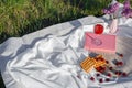 Still life and food photo. Cherry and waffle berries lie on a wicker round napkin and crumpled fabric