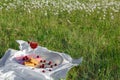 Still life and food photo. Cherry and waffle berries lie on a wicker round napkin and crumpled fabric