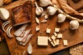 Still life of food in a rural style on a dark wood background, sliced lard and garlic, cheese, rye bread and onion, concept of Royalty Free Stock Photo