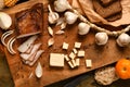 Still life of food in a rural style on a dark wood background, sliced lard and garlic, cheese, rye bread and onion, concept of Royalty Free Stock Photo