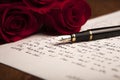 Still life of a fountain pen, paper and flowers roses Royalty Free Stock Photo