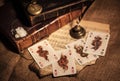 a still life of four playing cards on burlap and a beautiful still life with old books and a clock Royalty Free Stock Photo