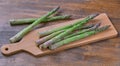 Still life with fresh green Asparagus stalks on wooden chopping board Royalty Free Stock Photo