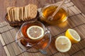 Still life of fresh lemons on a bamboo napkin with cup of tea Royalty Free Stock Photo