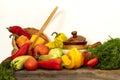 Still life of fresh natural vegetables on a wooden table against white background. Peppers, zucchini, tomatoes, dill Royalty Free Stock Photo