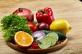 Still life of fresh organic vegetables on wooden plate over wooden background, selective focus, close-up Royalty Free Stock Photo