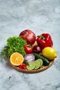 Still life of fresh organic vegetables on wooden plate over white background, selective focus, close-up Royalty Free Stock Photo