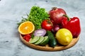 Still life of fresh organic vegetables on wooden plate over white background, selective focus, close-up Royalty Free Stock Photo