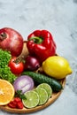 Still life of fresh organic vegetables on wooden plate over wooden background, selective focus, close-up Royalty Free Stock Photo