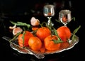 Still life of fresh tangerines with leaves on a tray
