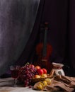 Still life with fruit in wicker basket with violin Royalty Free Stock Photo