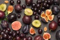 Still life of fruits. Bunch of grapes. Figs and plums. Cut figs plum halves, plum pits Royalty Free Stock Photo