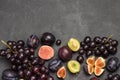 Still life of fruits. Bunch of grapes. Figs and plums. Cut figs, plum halves Royalty Free Stock Photo