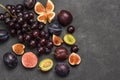 Still life of fruits. Bunch of grapes. Figs and plums. Cut figs, plum halves, plum pits Royalty Free Stock Photo