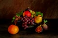 Still life with fruits: grape, apple, fig, pear on the antique copper tin plate Royalty Free Stock Photo