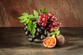 Still life with fruits: grape, fig in the antique copper tin cup Royalty Free Stock Photo