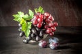 Still life with fruits: grape, plum in the antique copper tin cup Royalty Free Stock Photo