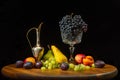 Still life with fruits on a round wooden table and black background. Royalty Free Stock Photo