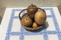Still life with fruits in wooden basket on table covered with white cloth with blue tracery Royalty Free Stock Photo