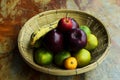 Still life fruts with apple banana and orange in basket weave on wooden table